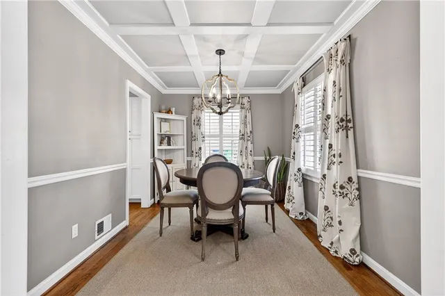 a dining room with furniture a chandelier and window