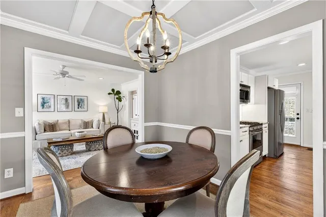a view of a dining room with furniture wooden floor and chandelier