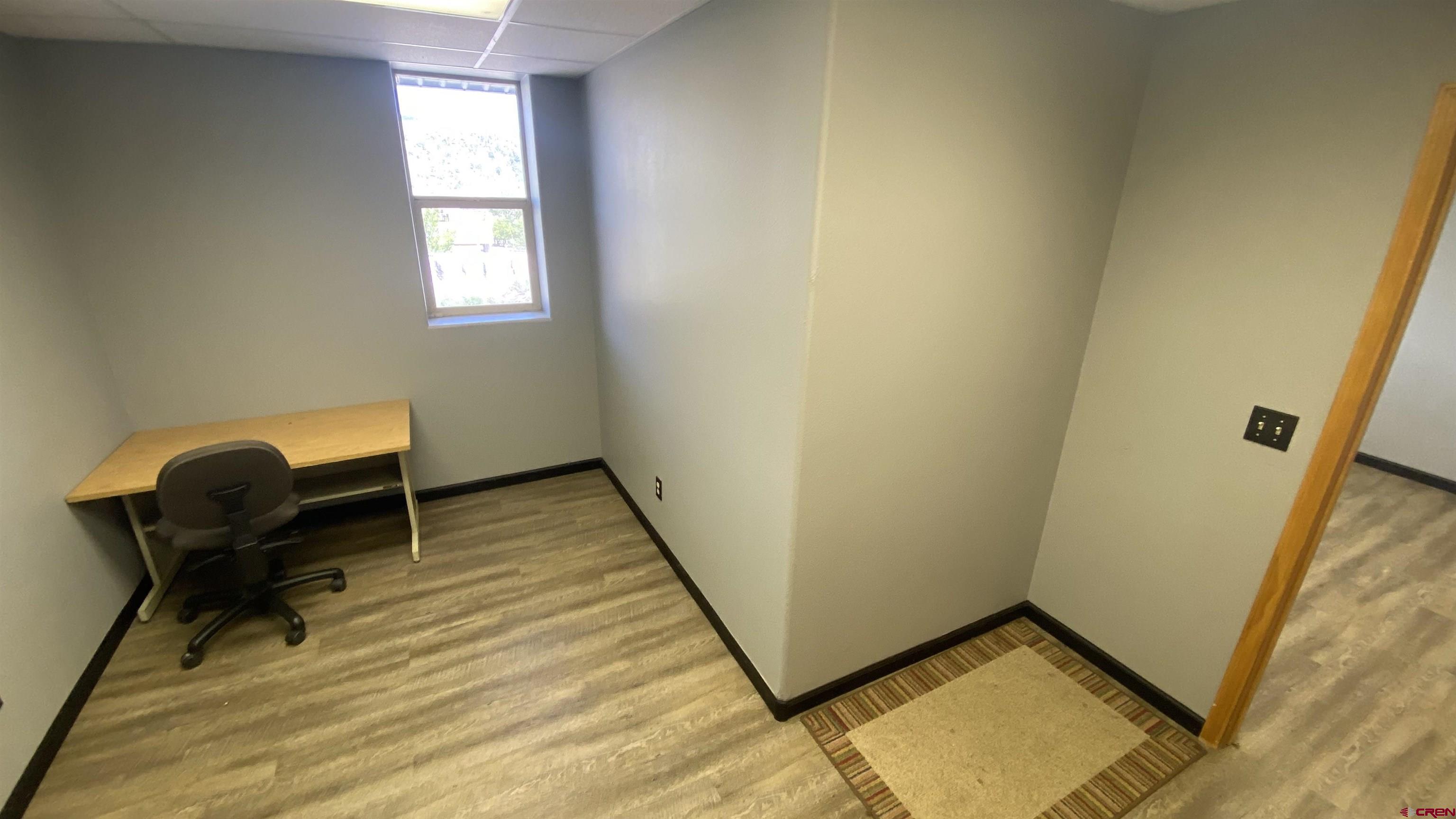 146 Sawyer Drive, Unit B Durango, CO 81303 - Photo 2 of 8 a room with a chair and a window