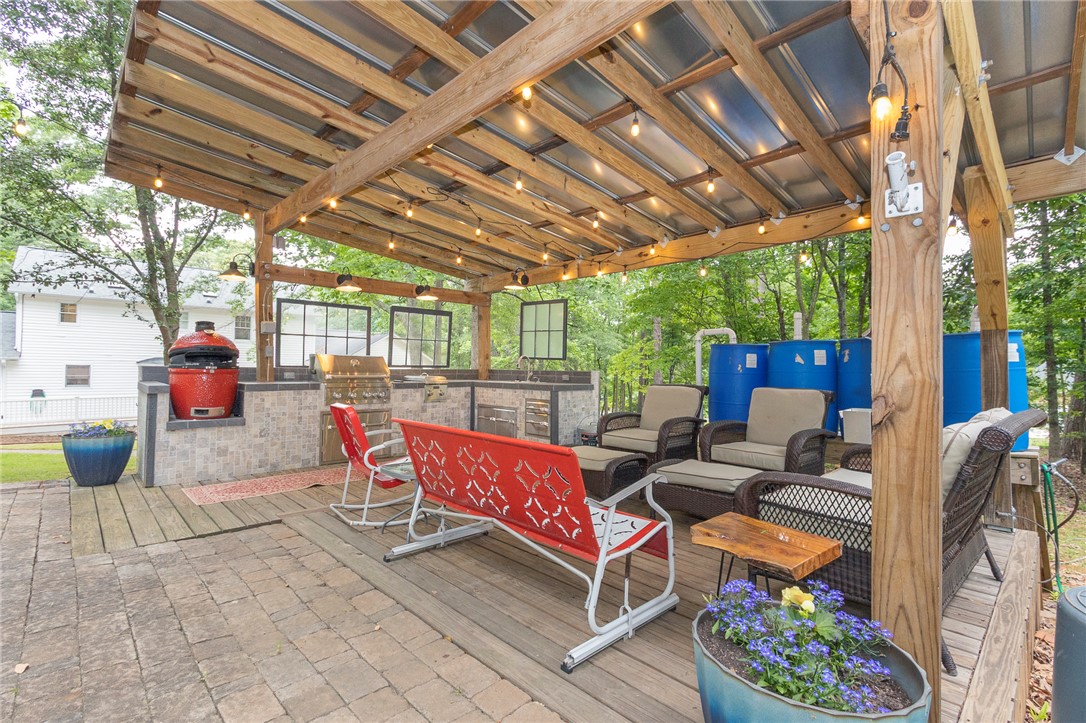 203 Oak Hollow Pendleton, SC 29670 - Photo 40 of 50 An inviting outdoor kitchen area and lounge space, perfect for entertaining guests.