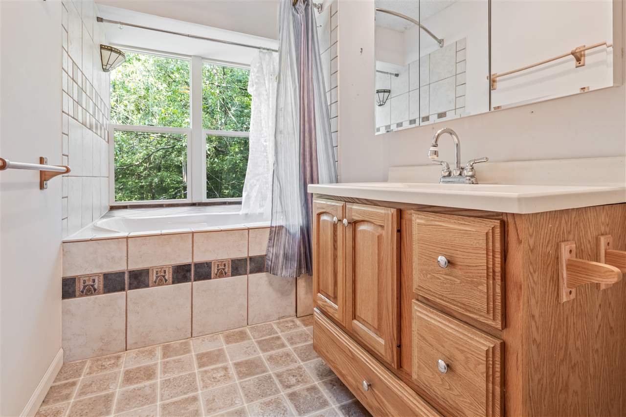 11064 Cemetery Road Capron, IL 61012 - Photo 22 of 40 a bathroom with a double vanity sink and mirror