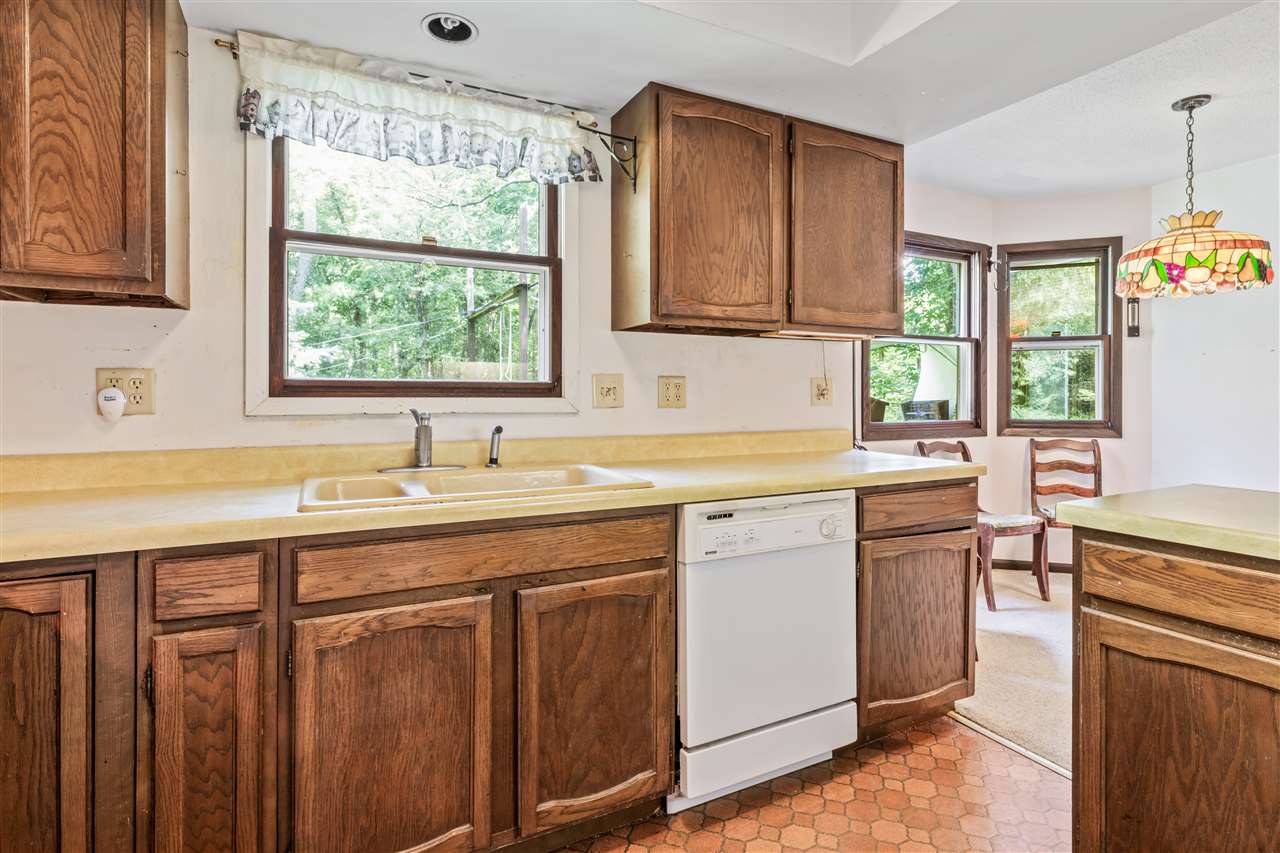 11064 Cemetery Road Capron, IL 61012 - Photo 5 of 40 a kitchen with stainless steel appliances granite countertop a sink stove and cabinets