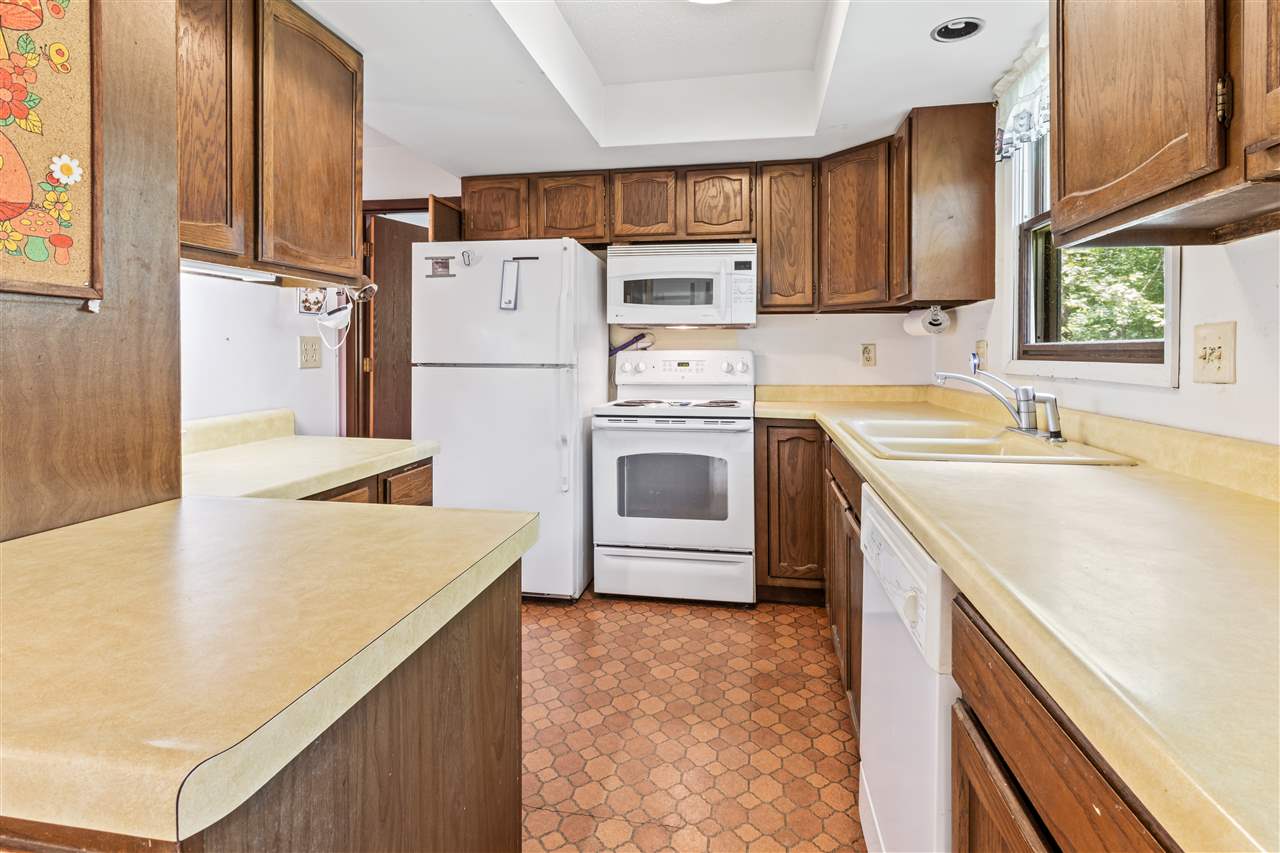 11064 Cemetery Road Capron, IL 61012 - Photo 7 of 40 a kitchen with a sink a stove a refrigerator and cabinets