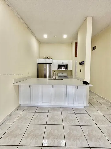 a kitchen with stainless steel appliances a stove top oven and cabinets