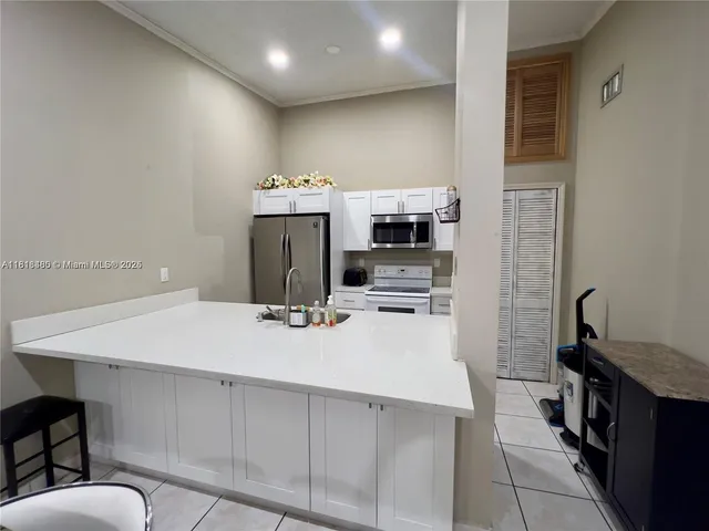 a kitchen with stainless steel appliances a stove refrigerator sink and stove