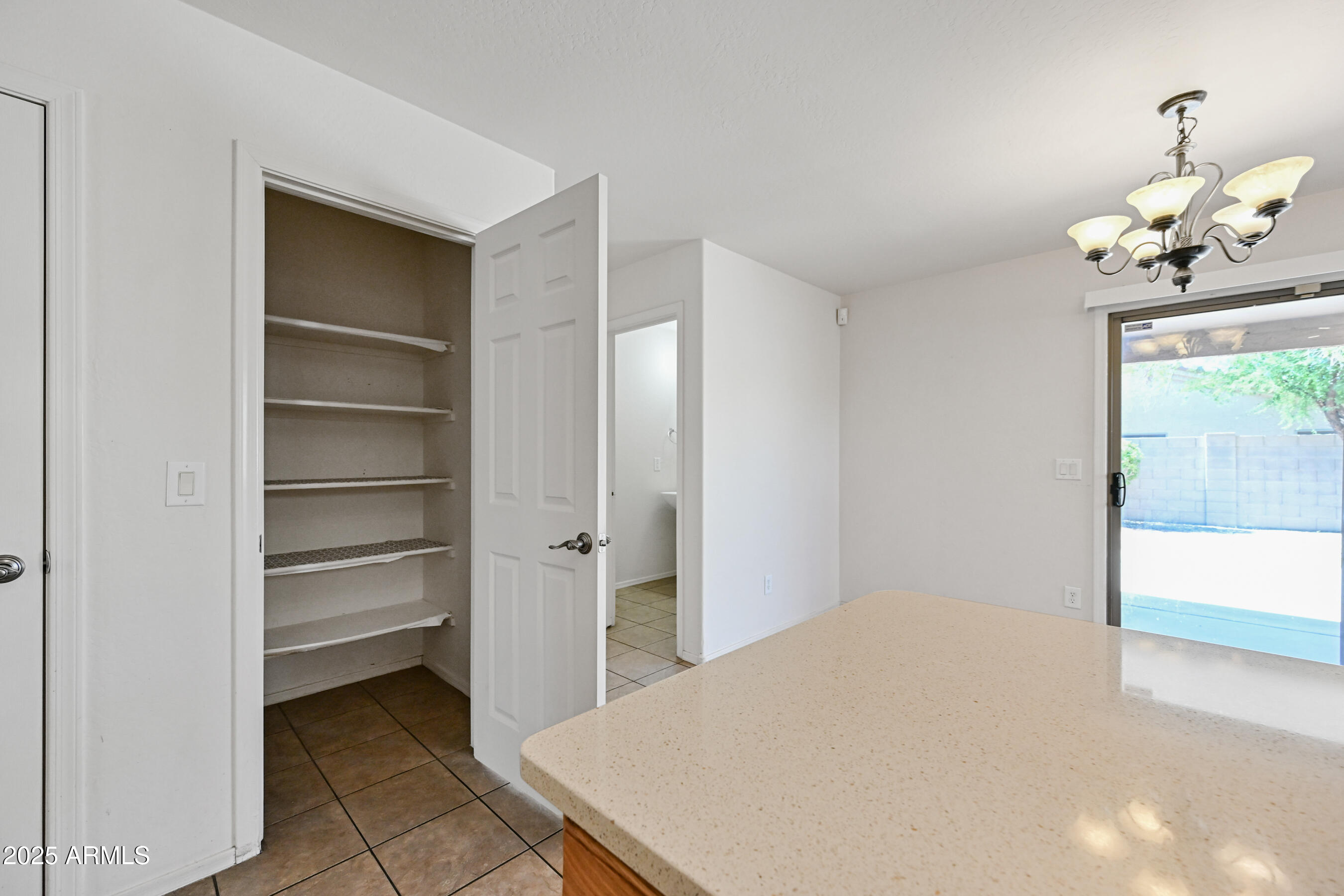 3726 West Pollack Street Phoenix, AZ 85041 - Photo 11 of 27 a bedroom with a bed and a chandelier