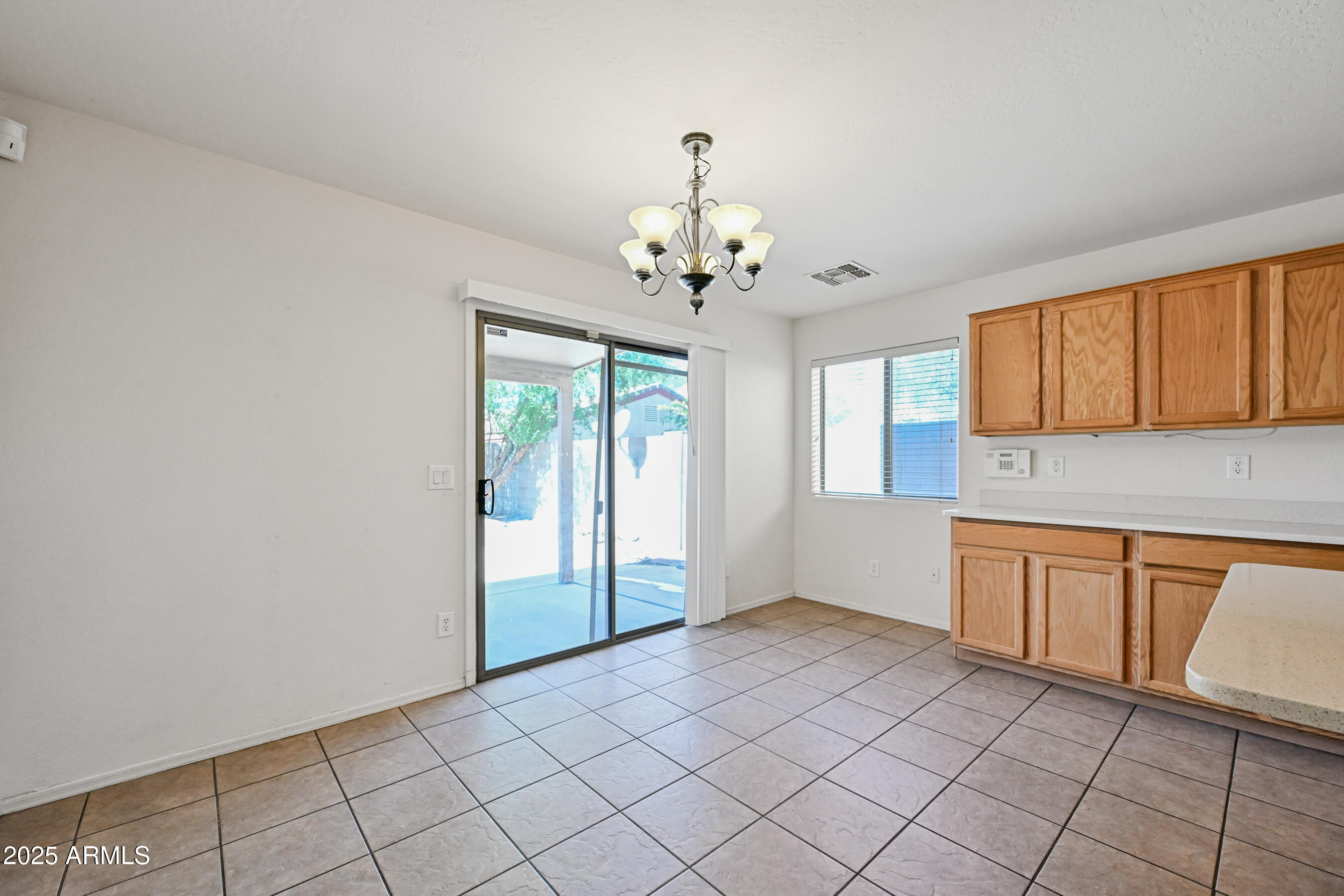 3726 West Pollack Street Phoenix, AZ 85041 - Photo 12 of 27 a large white kitchen with granite countertop cabinets a sink and a window