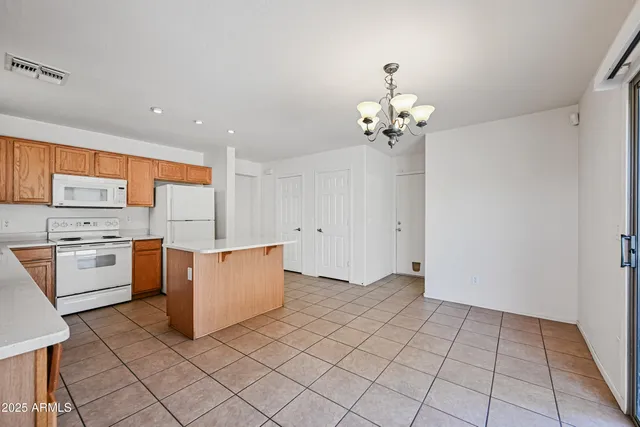 a view of kitchen with a sink cabinets and window