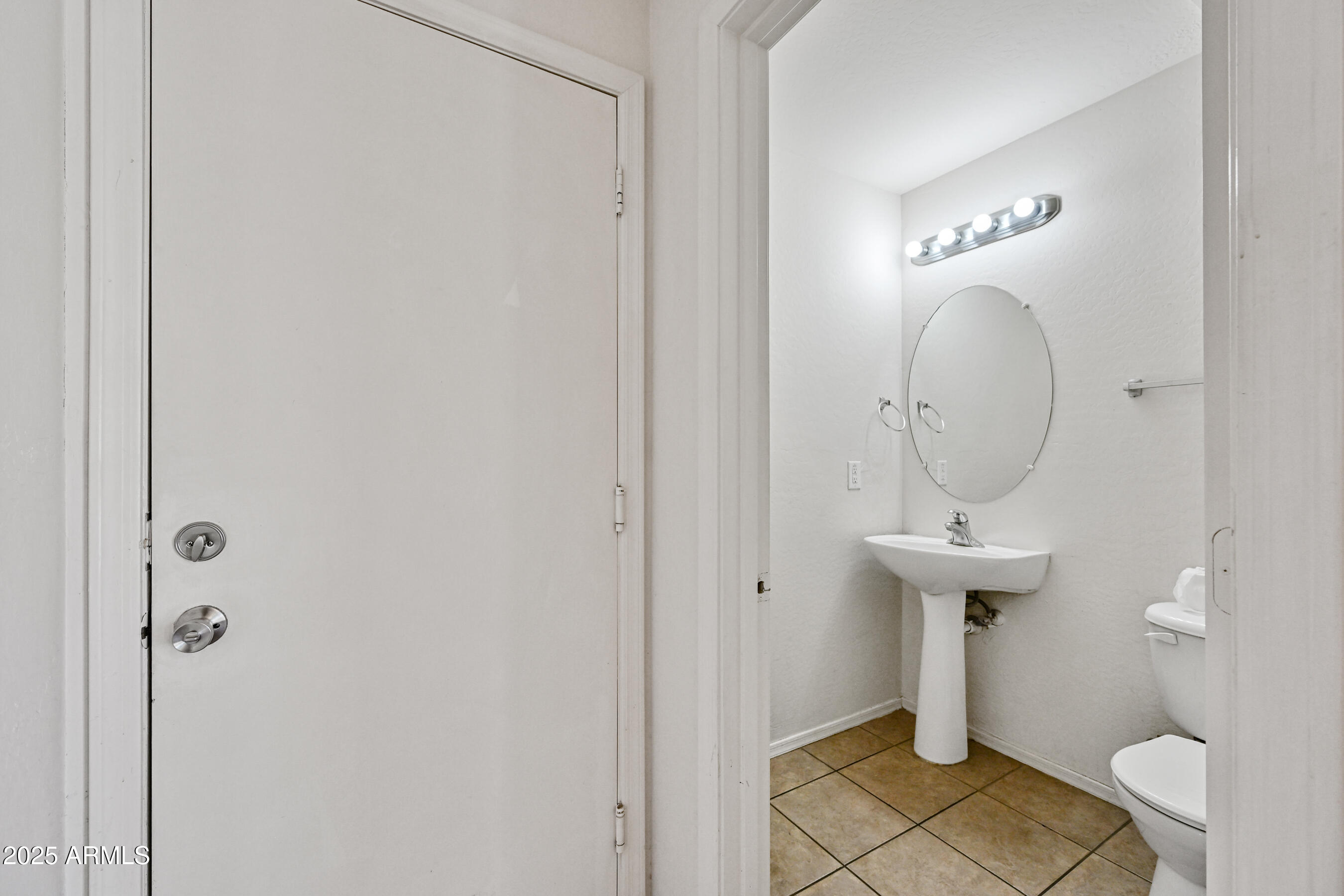 3726 West Pollack Street Phoenix, AZ 85041 - Photo 14 of 27 a bathroom with a sink a toilet and a mirror
