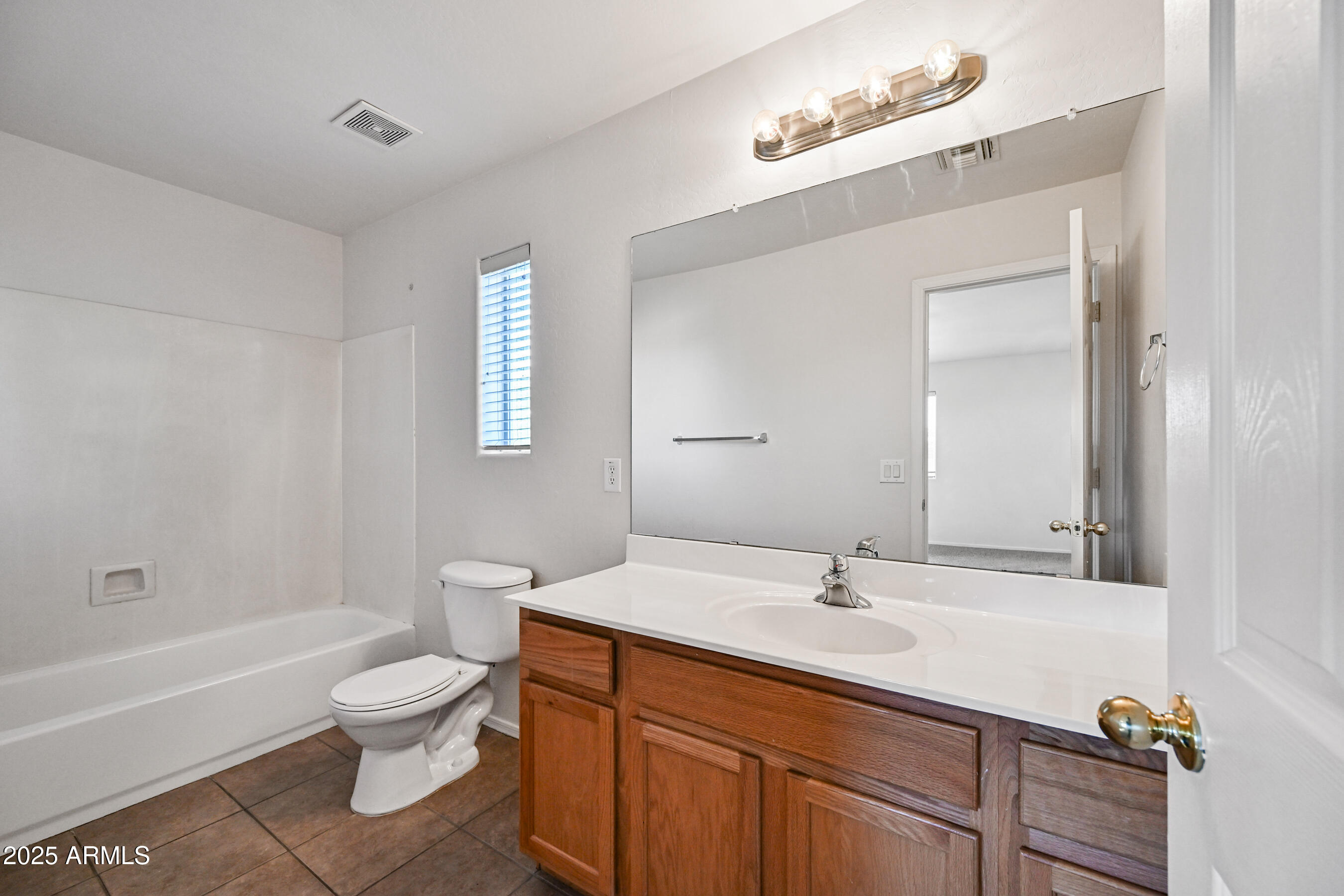 3726 West Pollack Street Phoenix, AZ 85041 - Photo 18 of 27 a bathroom with a sink a toilet and shower