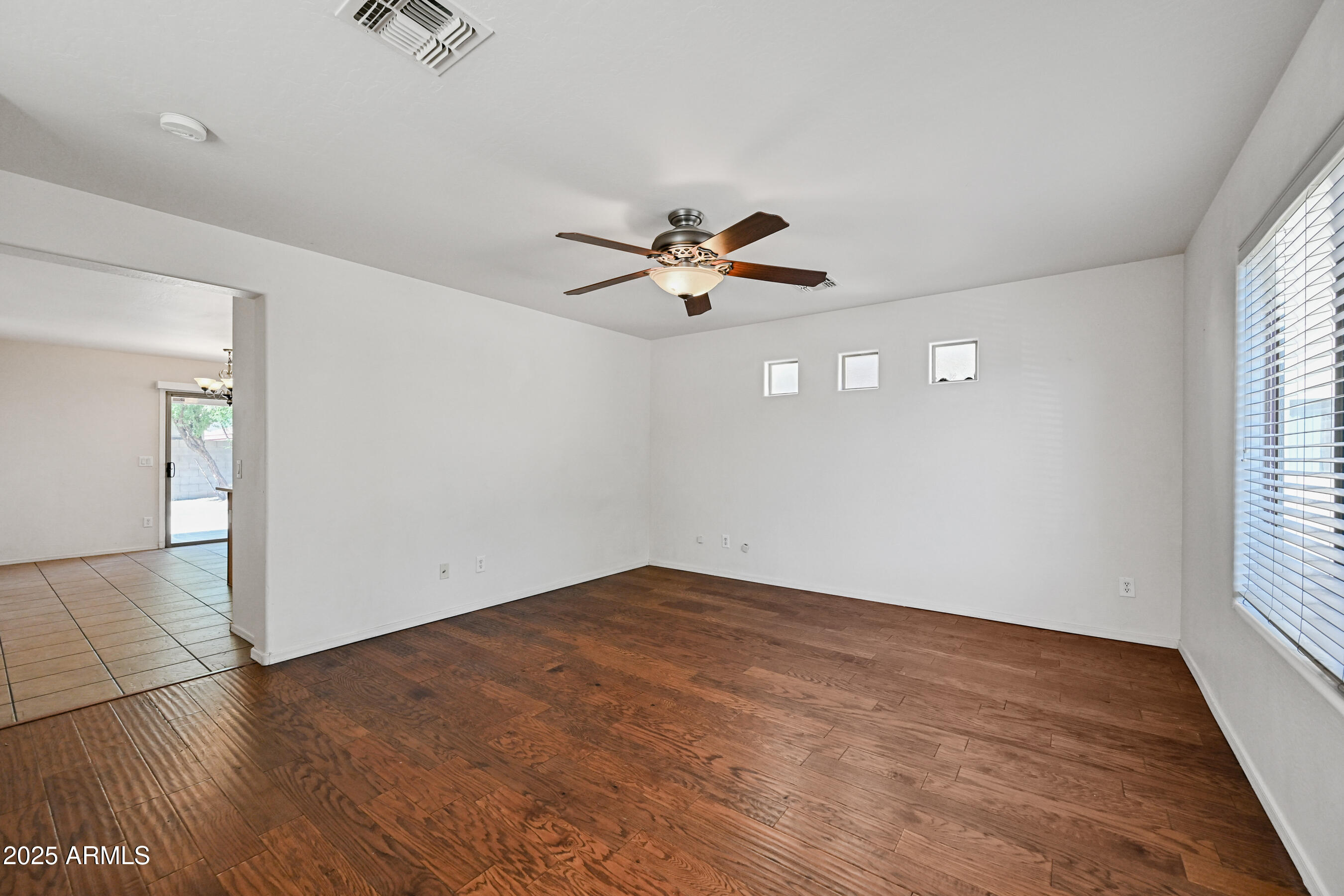 3726 West Pollack Street Phoenix, AZ 85041 - Photo 3 of 27 an empty room with fan and windows
