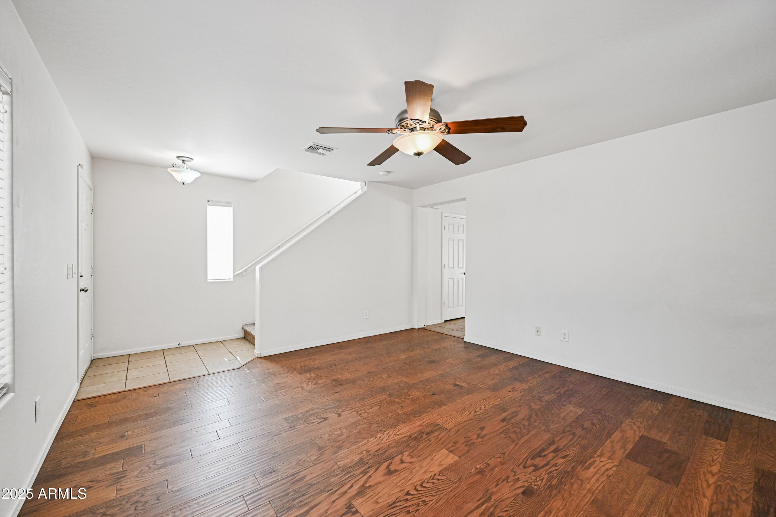 3726 West Pollack Street Phoenix, AZ 85041 - Photo 4 of 27 a view of an empty room with wooden floor
