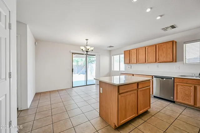 a kitchen with granite countertop a sink stove and cabinets