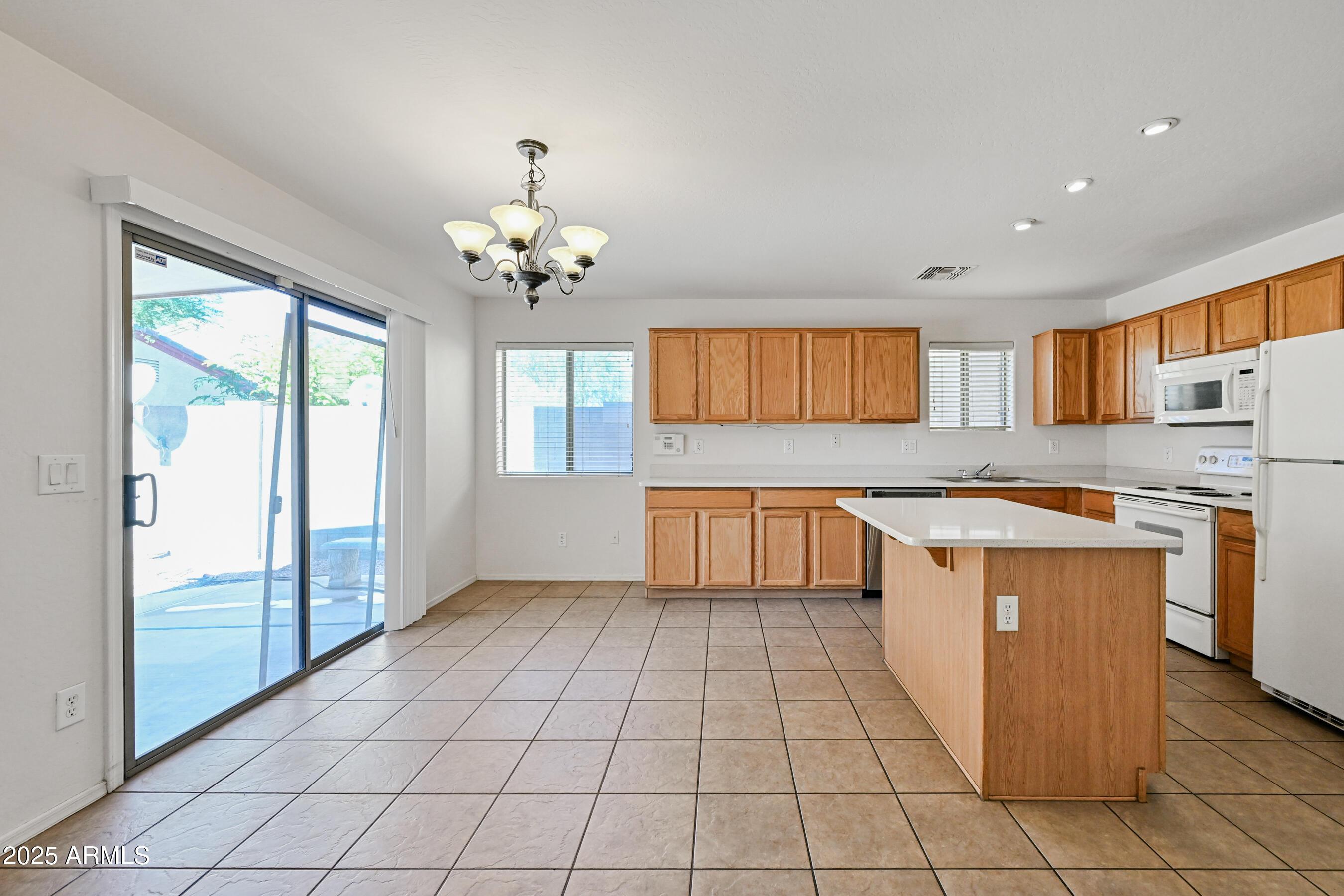 3726 West Pollack Street Phoenix, AZ 85041 - Photo 7 of 27 a kitchen with granite countertop a stove a sink and a refrigerator