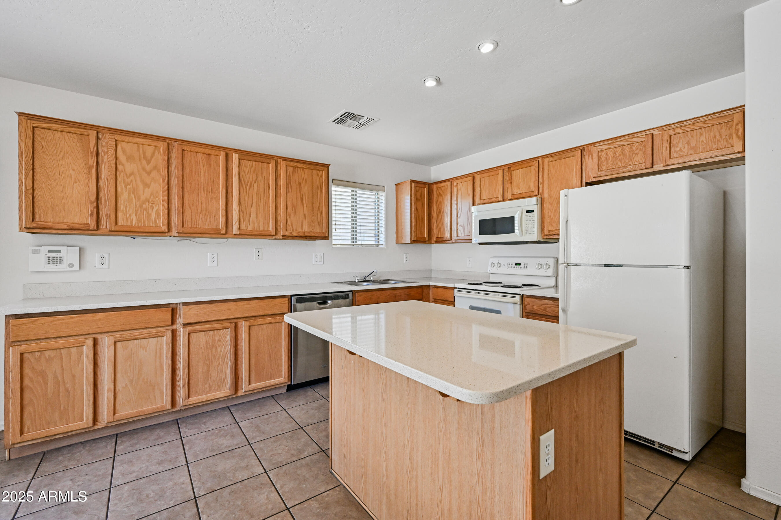 3726 West Pollack Street Phoenix, AZ 85041 - Photo 8 of 27 a kitchen with stainless steel appliances a refrigerator sink and cabinets