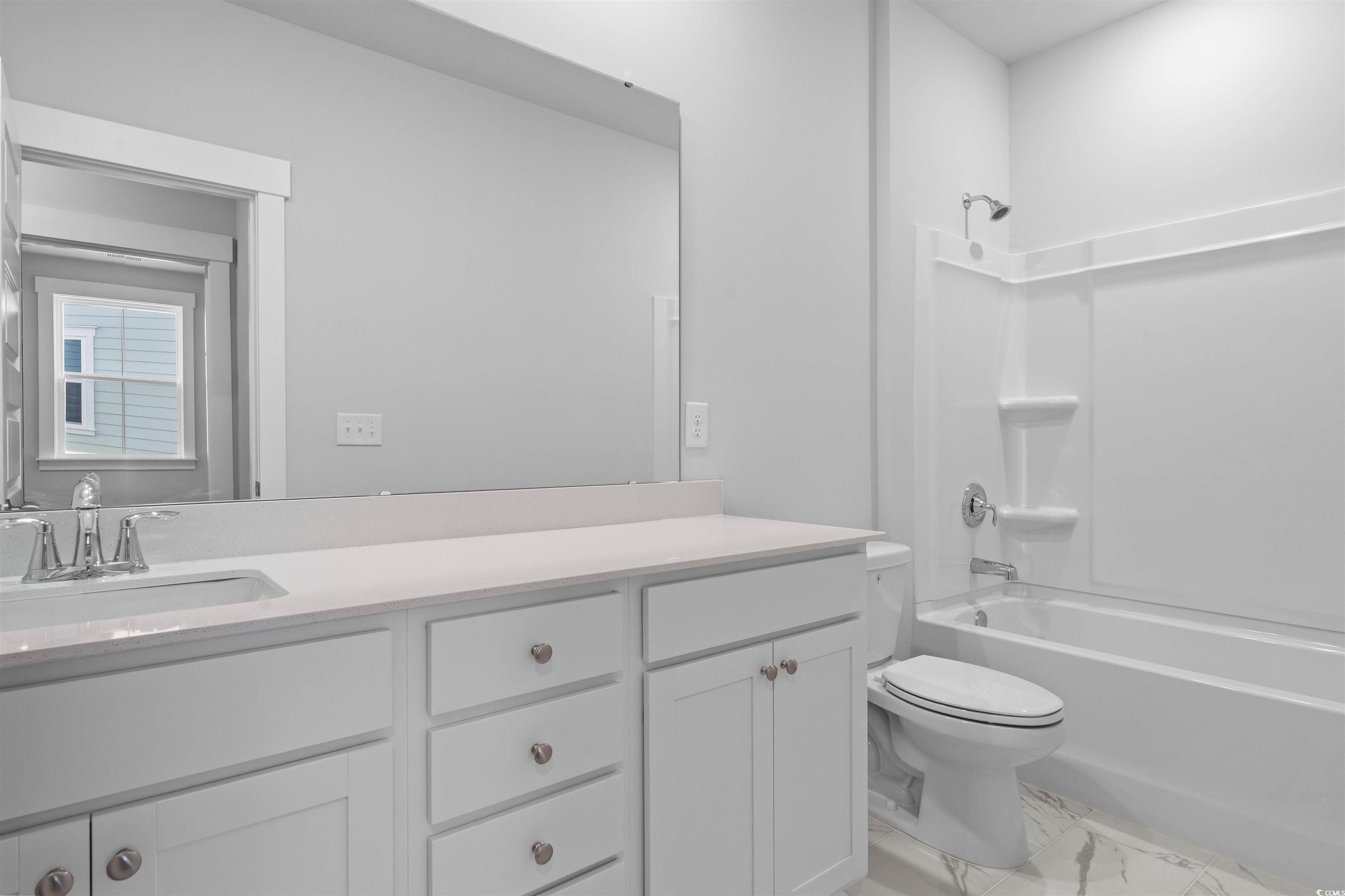 205 Atlantic Breeze Street Myrtle Beach, SC 29572 - Photo 17 of 28 Full bath with vanity, shower / bathtub combination, and light marble finish floors