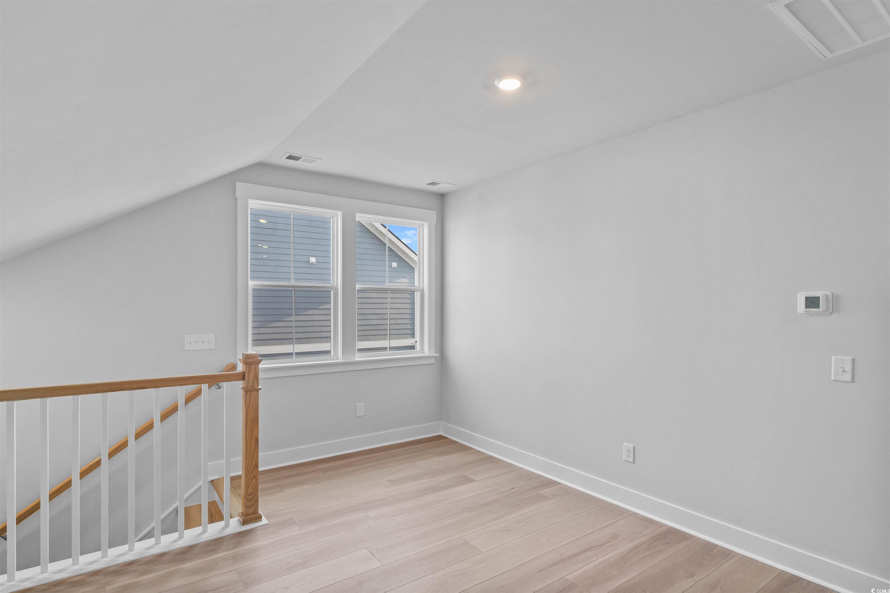205 Atlantic Breeze Street Myrtle Beach, SC 29572 - Photo 21 of 28 Bonus room with light wood-style flooring and vaulted ceiling