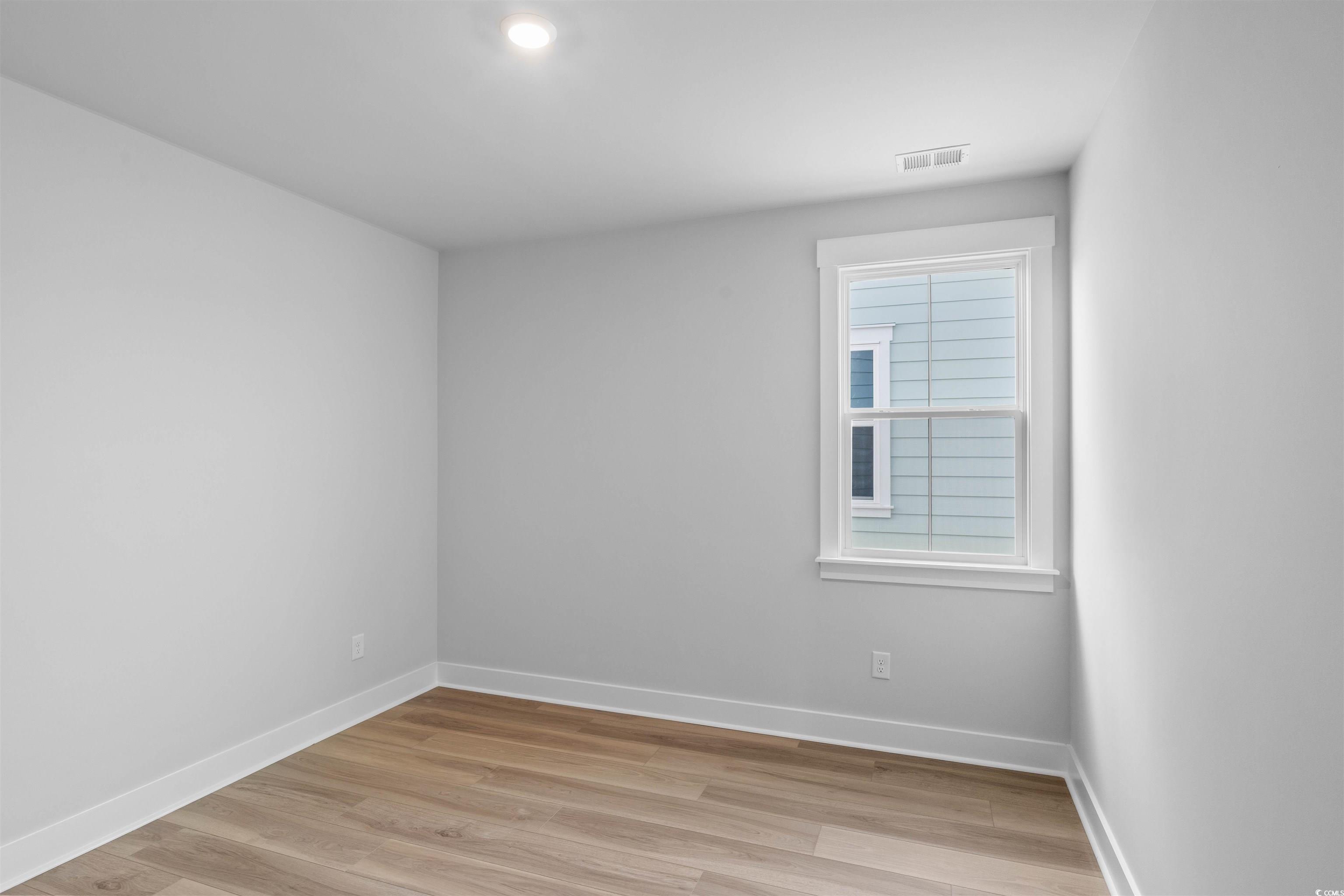 205 Atlantic Breeze Street Myrtle Beach, SC 29572 - Photo 8 of 28 Unfurnished room with baseboards and light wood-style floors