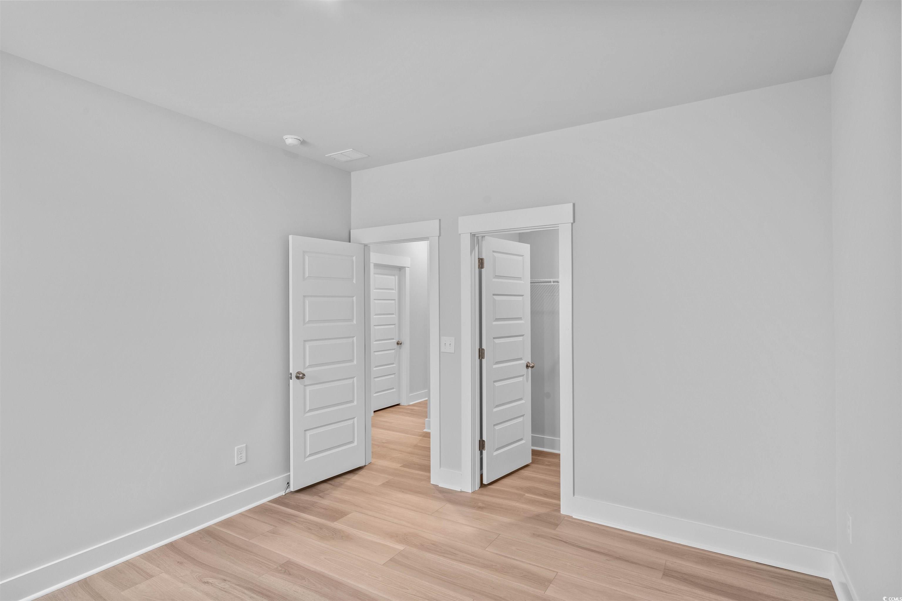 205 Atlantic Breeze Street Myrtle Beach, SC 29572 - Photo 9 of 28 Unfurnished bedroom with a spacious closet and light wood-style floors