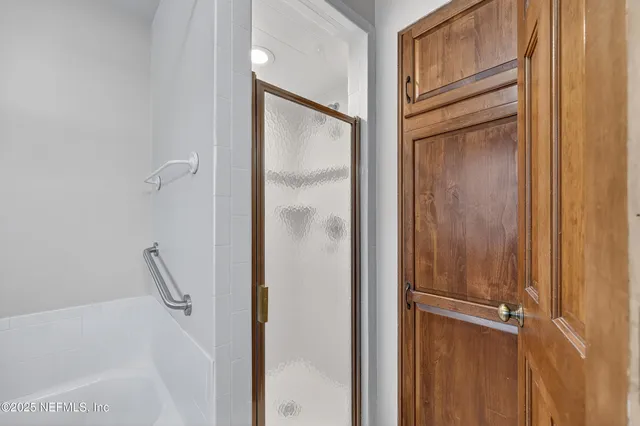a bathroom with a glass shower door
