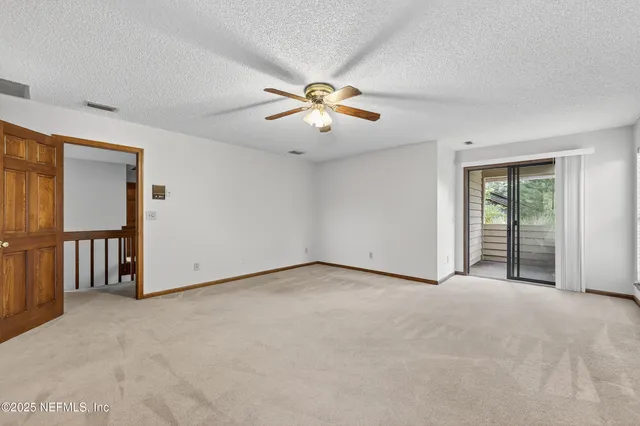 a view of empty room with ceiling fan