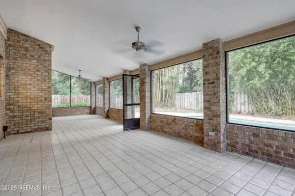 a spacious bedroom with a large bed and a large window