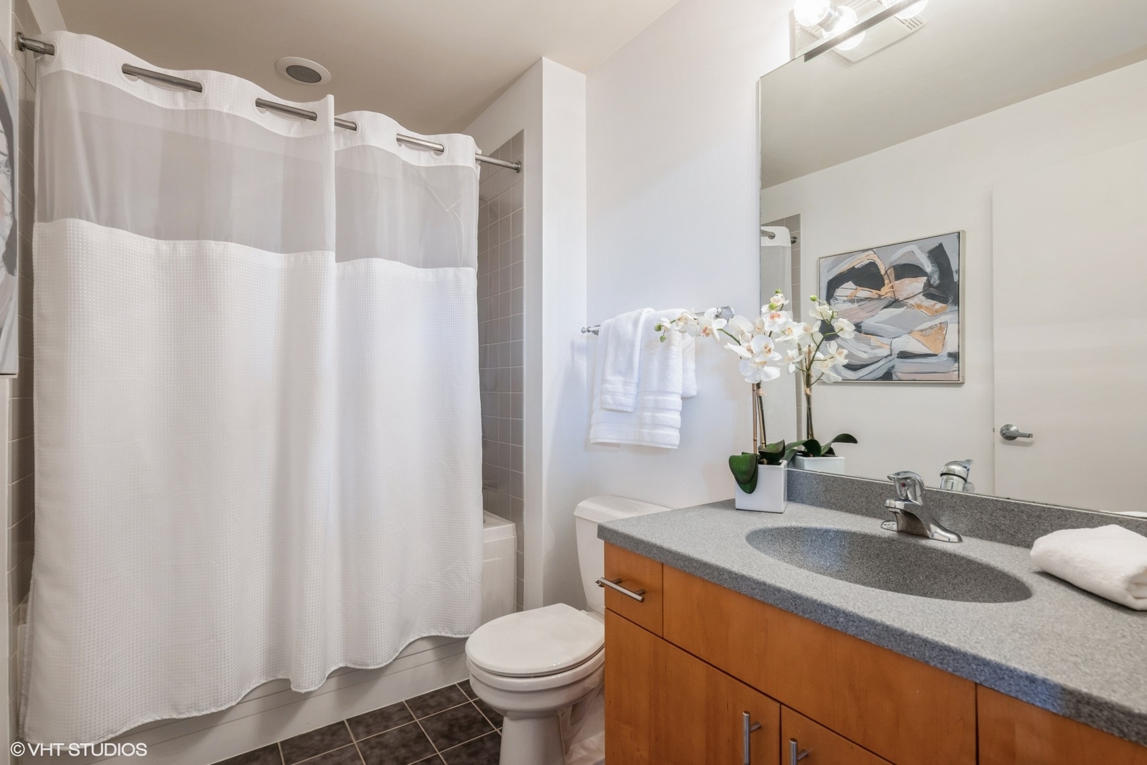 1040 West Adams Street, Unit 442 Chicago, IL 60607 - Photo 20 of 23 a bathroom with a granite countertop sink and a mirror