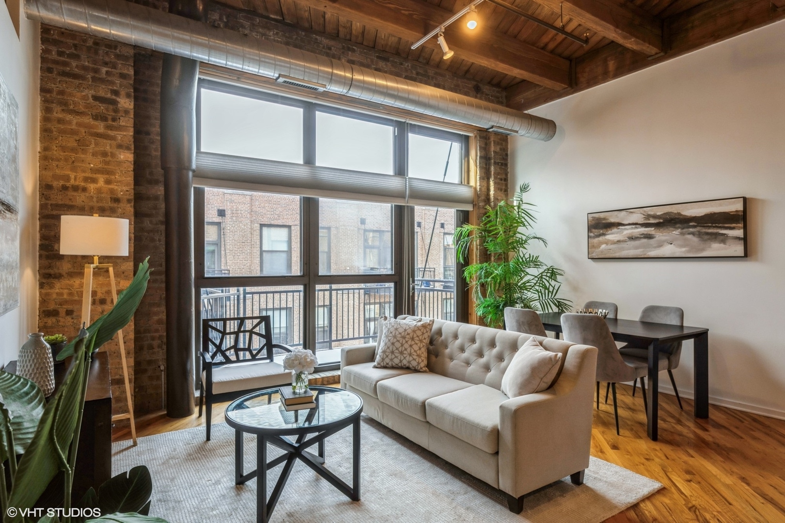 1040 West Adams Street, Unit 442 Chicago, IL 60607 - Photo 2 of 23 a living room with furniture and a floor to ceiling window