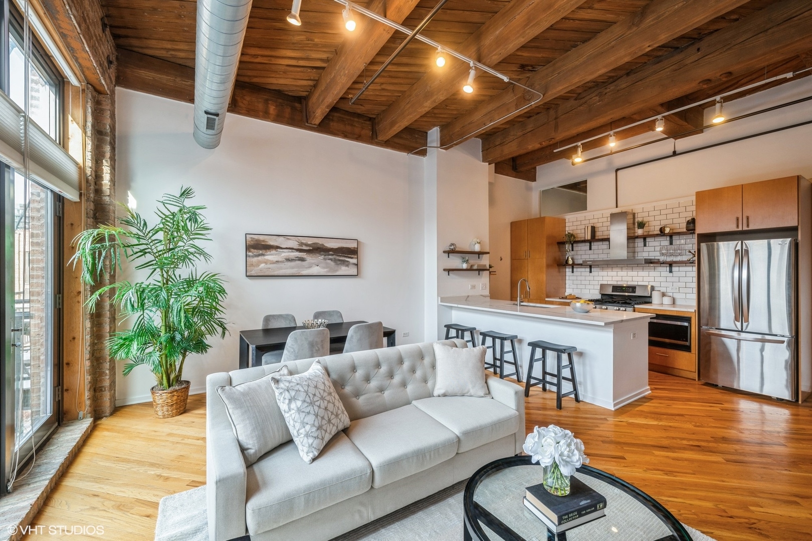 1040 West Adams Street, Unit 442 Chicago, IL 60607 - Photo 5 of 23 a balcony with furniture and wooden floor