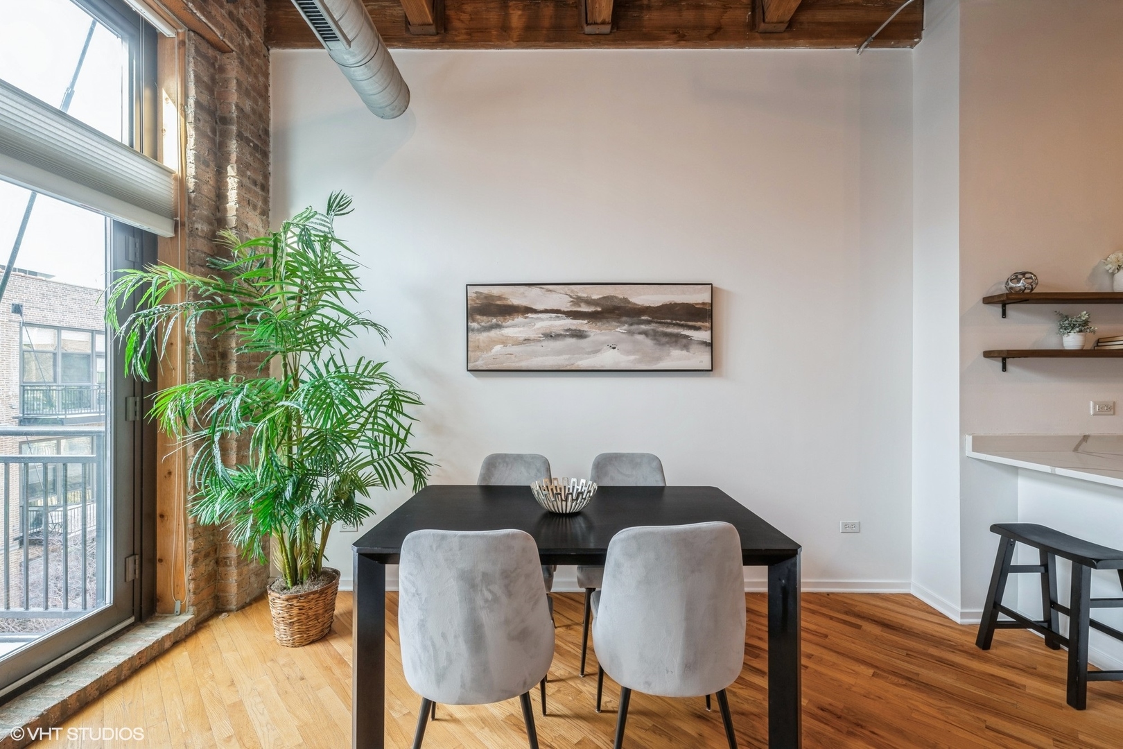 1040 West Adams Street, Unit 442 Chicago, IL 60607 - Photo 6 of 23 a view of a dining room with furniture and a potted plant
