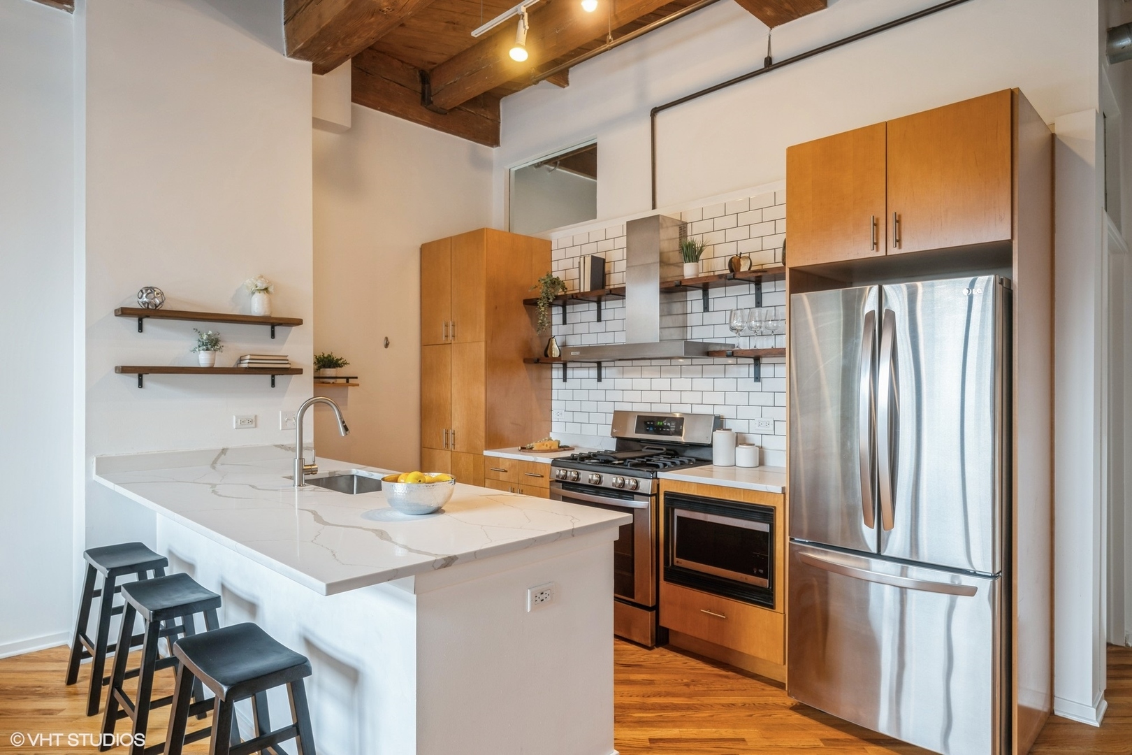 1040 West Adams Street, Unit 442 Chicago, IL 60607 - Photo 8 of 23 a kitchen that has a refrigerator a stove and a sink with wooden floor
