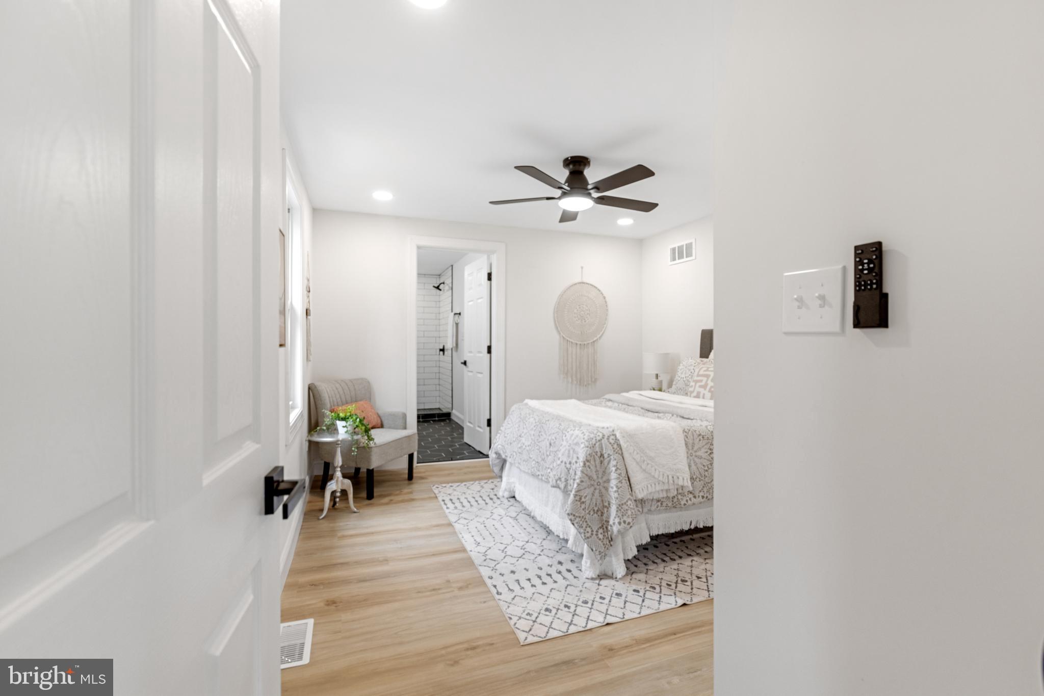 766 Highland Road Deptford, NJ 08096 - Photo 12 of 41 a bedroom with a large bed and a chandelier