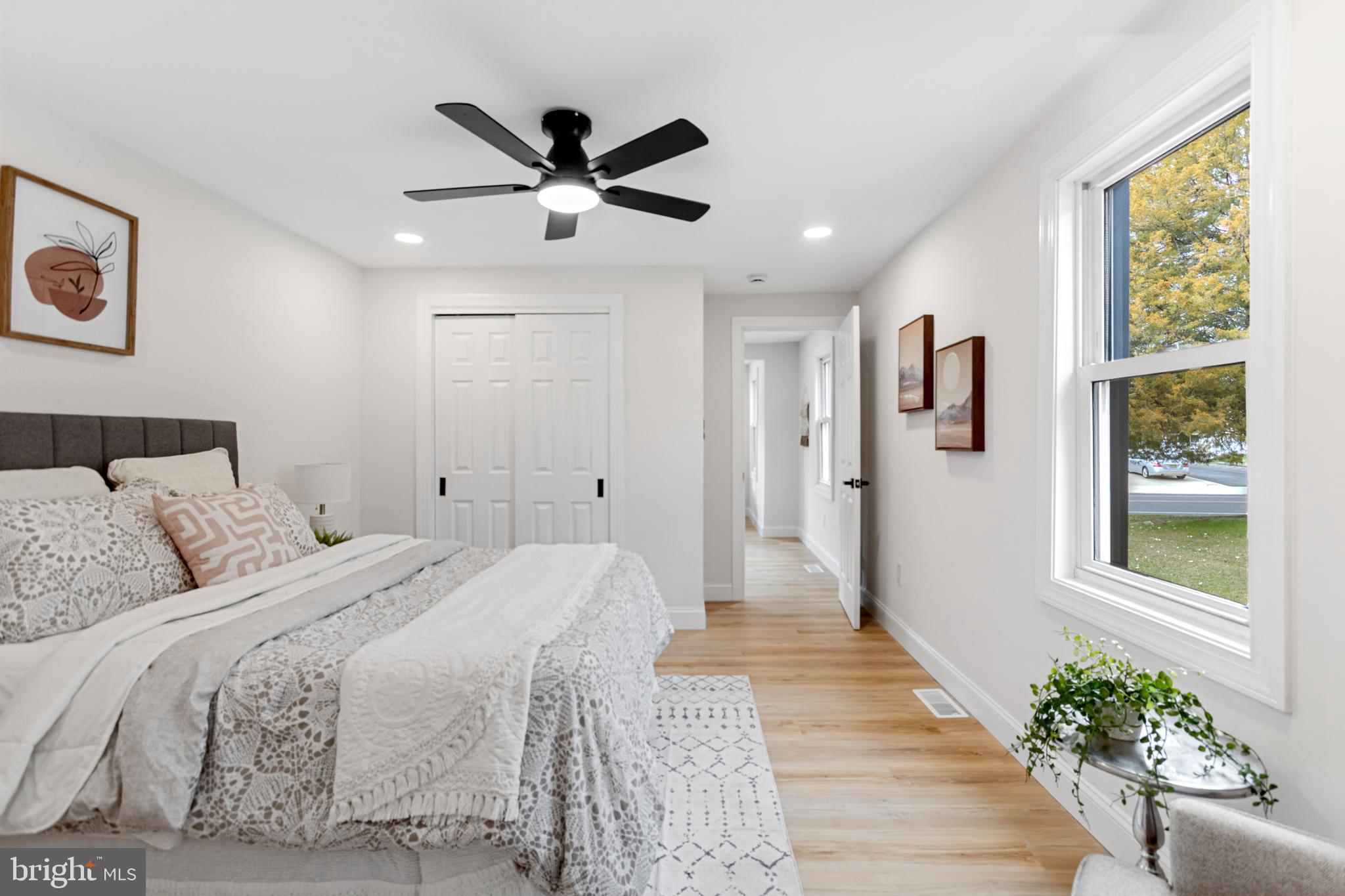 766 Highland Road Deptford, NJ 08096 - Photo 14 of 41 a bedroom with a large bed and a chandelier