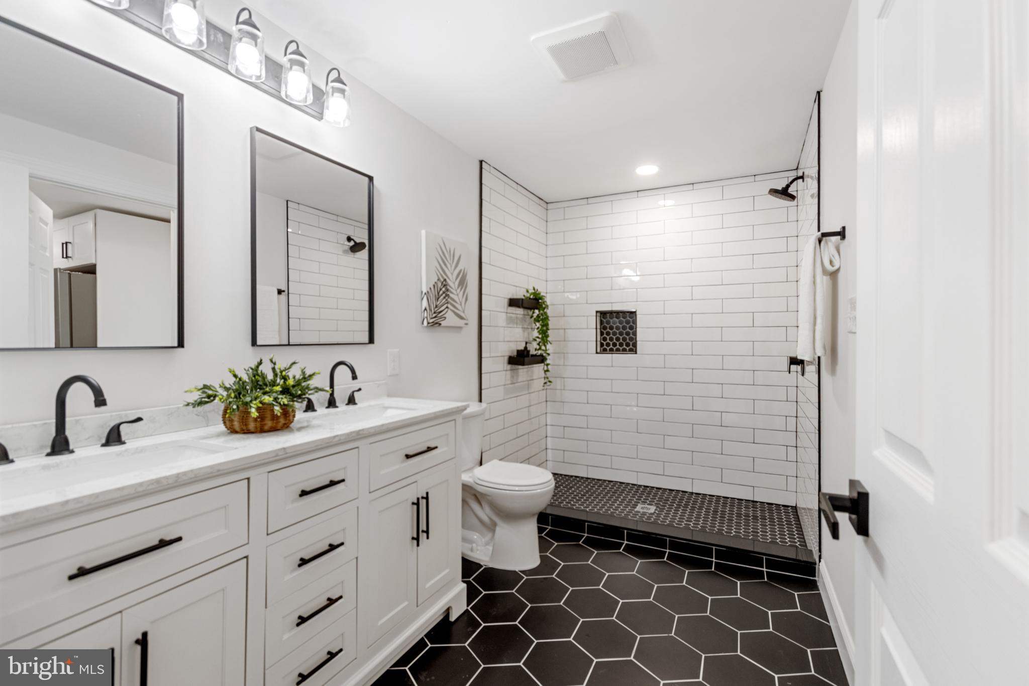 766 Highland Road Deptford, NJ 08096 - Photo 15 of 41 a bathroom with a double vanity sink mirror and toilet