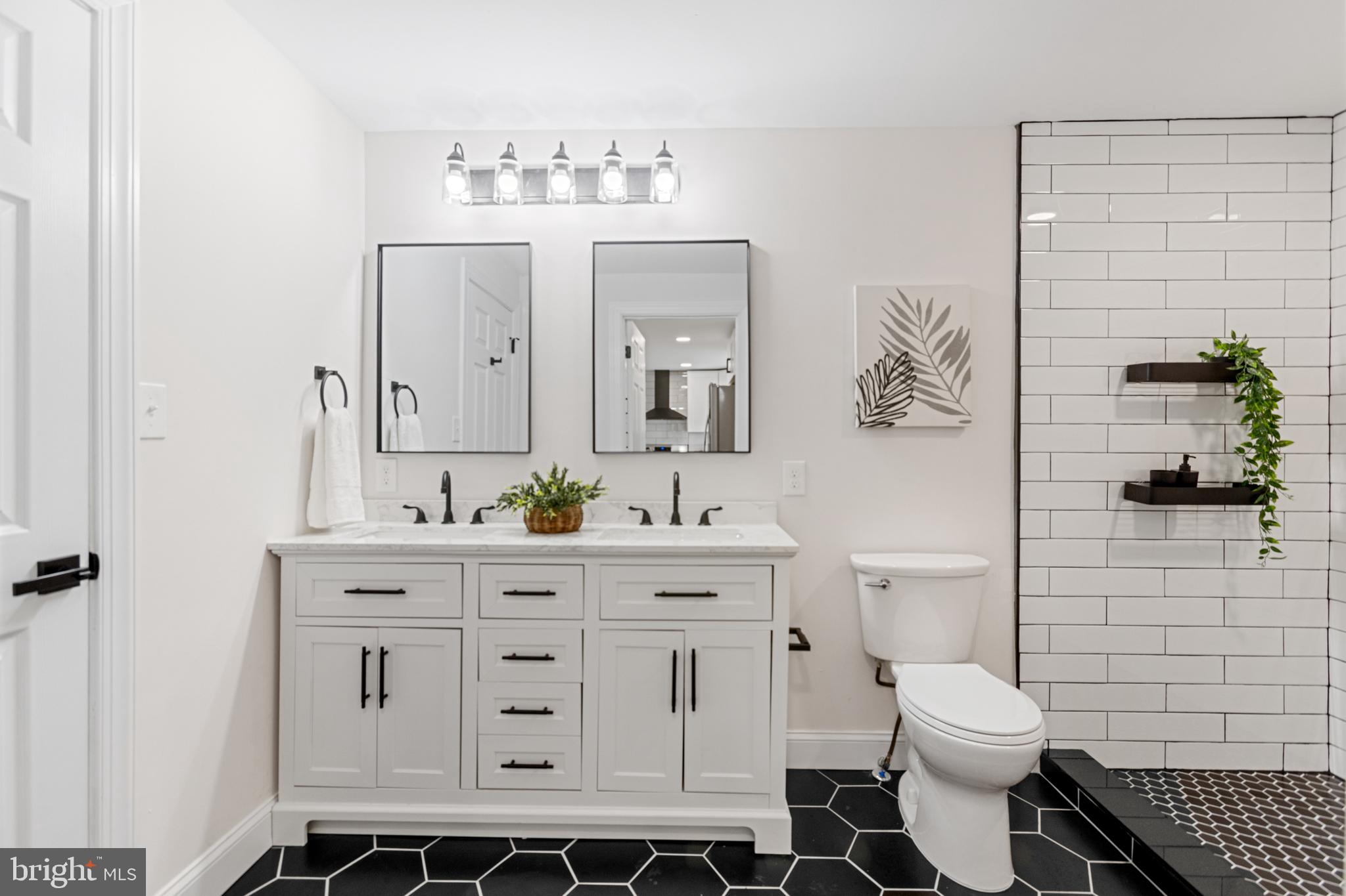 766 Highland Road Deptford, NJ 08096 - Photo 16 of 41 a bathroom with a toilet a sink and mirror