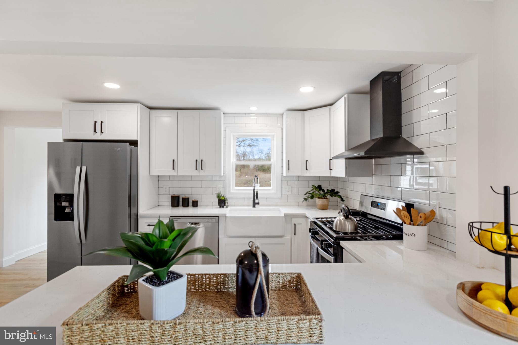 766 Highland Road Deptford, NJ 08096 - Photo 17 of 41 a kitchen with stainless steel appliances a dining table chairs and refrigerator