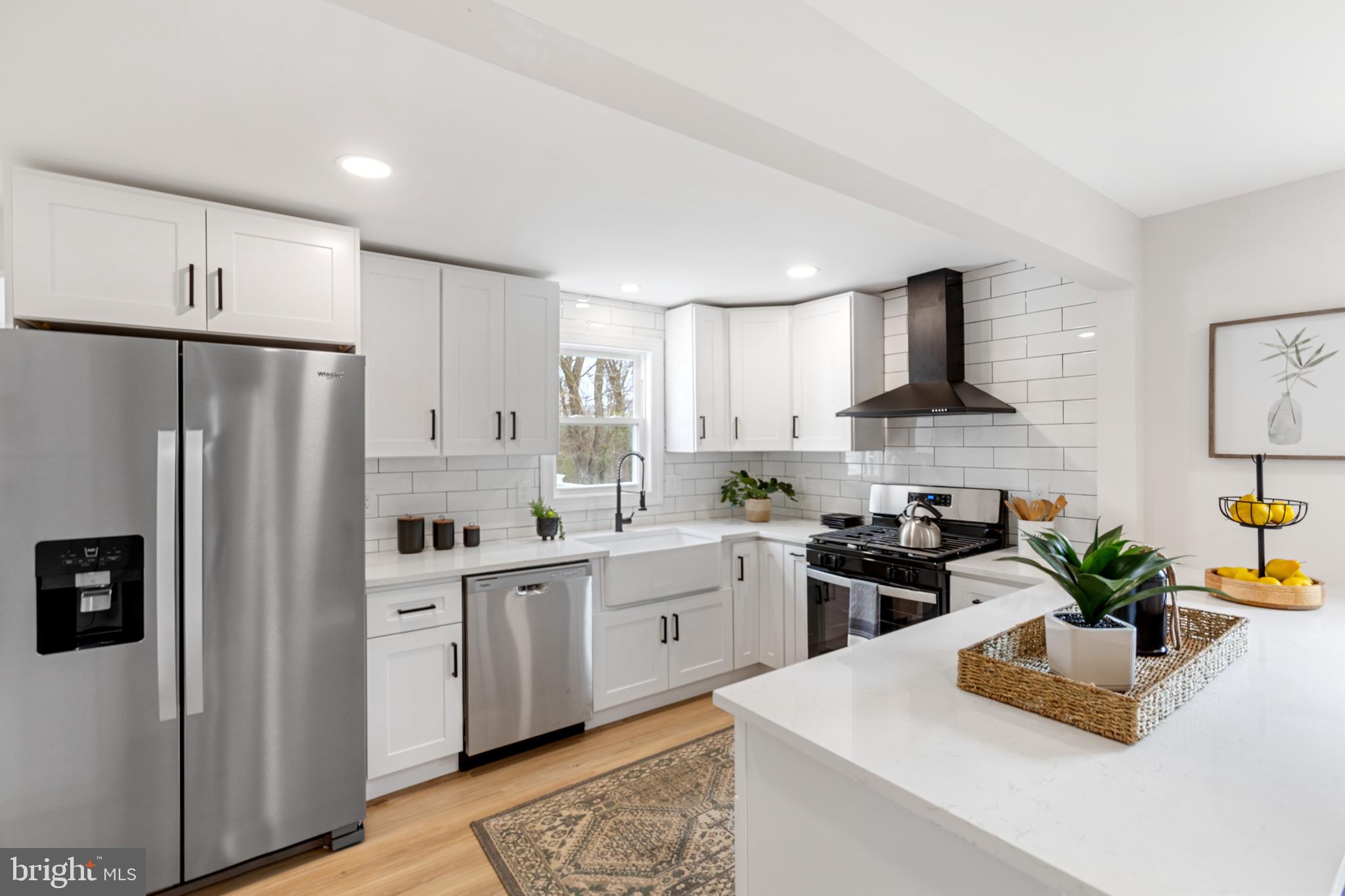766 Highland Road Deptford, NJ 08096 - Photo 19 of 41 a kitchen with white cabinets and stainless steel appliances