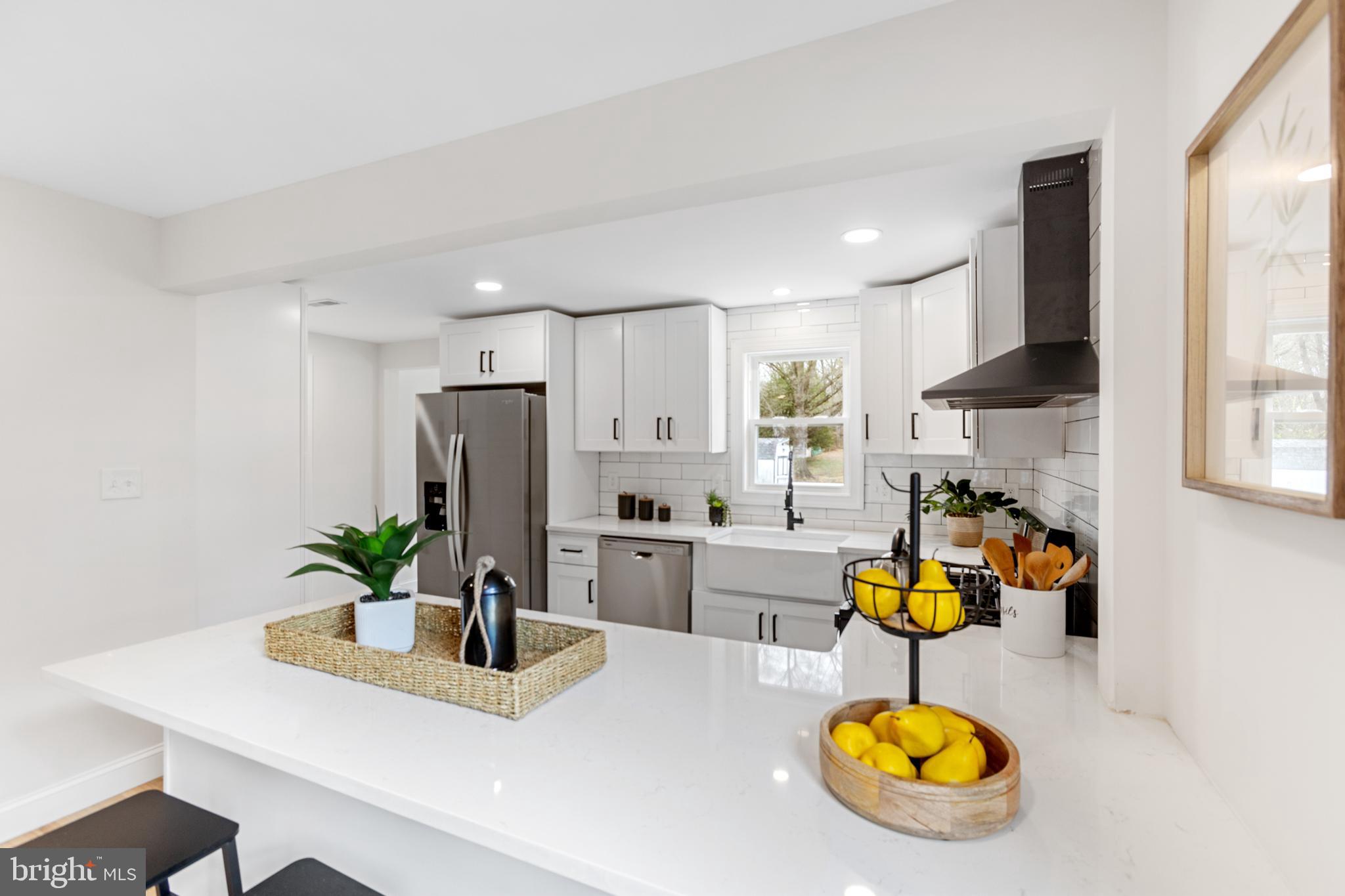 766 Highland Road Deptford, NJ 08096 - Photo 21 of 41 a kitchen with a sink a refrigerator and chairs