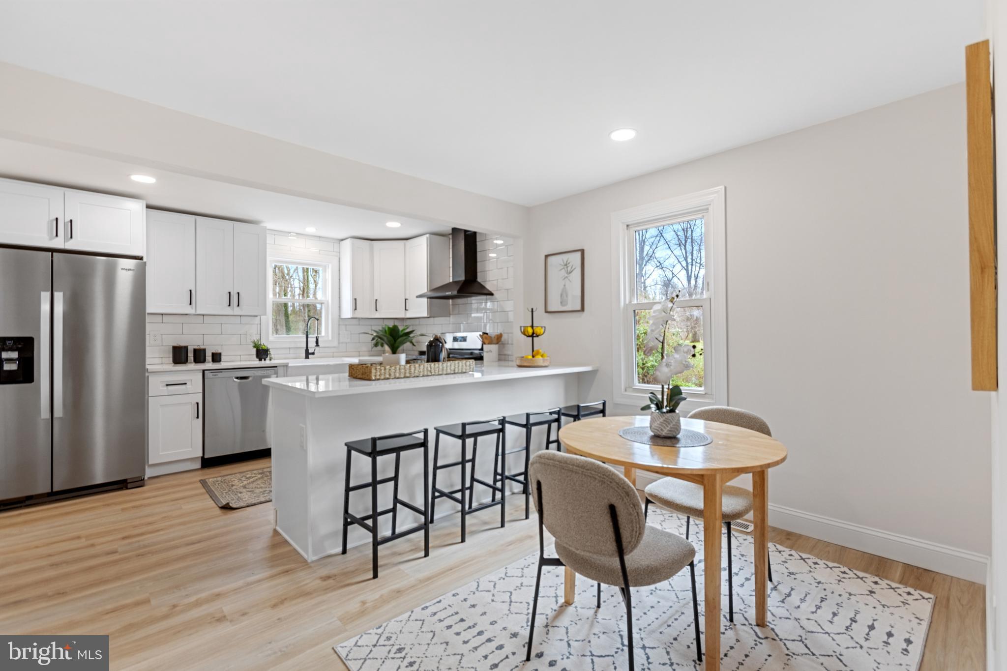 766 Highland Road Deptford, NJ 08096 - Photo 22 of 41 a kitchen with white cabinets and stainless steel appliances