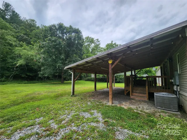 a view of a backyard with table and chairs under an umbrella