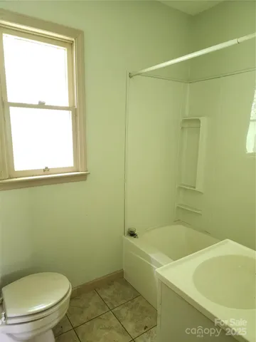 a white bath tub sitting next to a toilet