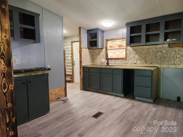 a kitchen with stainless steel appliances granite countertop a stove and a sink