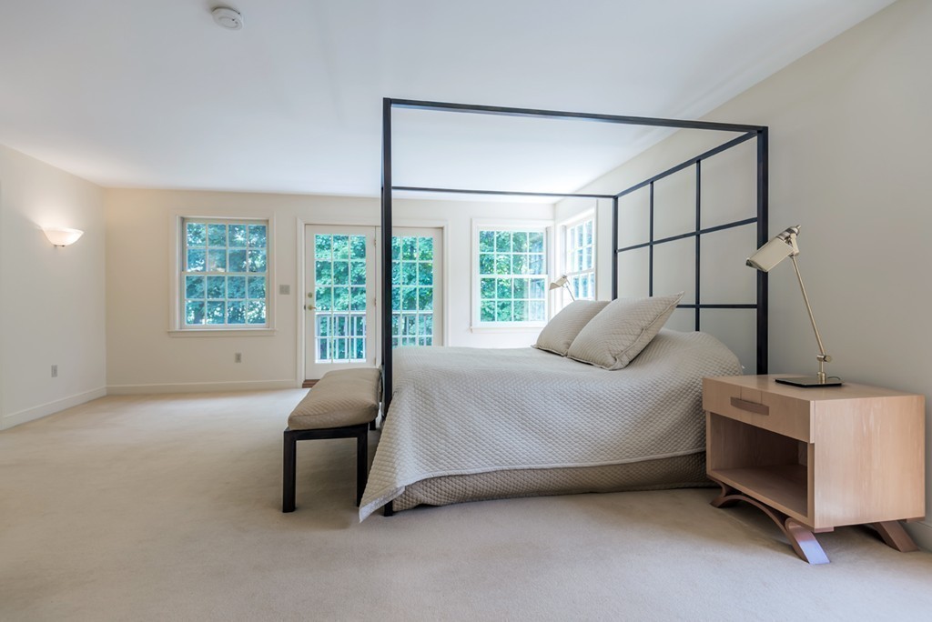 18 Wildwood Road Andover, MA 01810 - Photo 20 of 30 a bed sitting in a bedroom next to a window