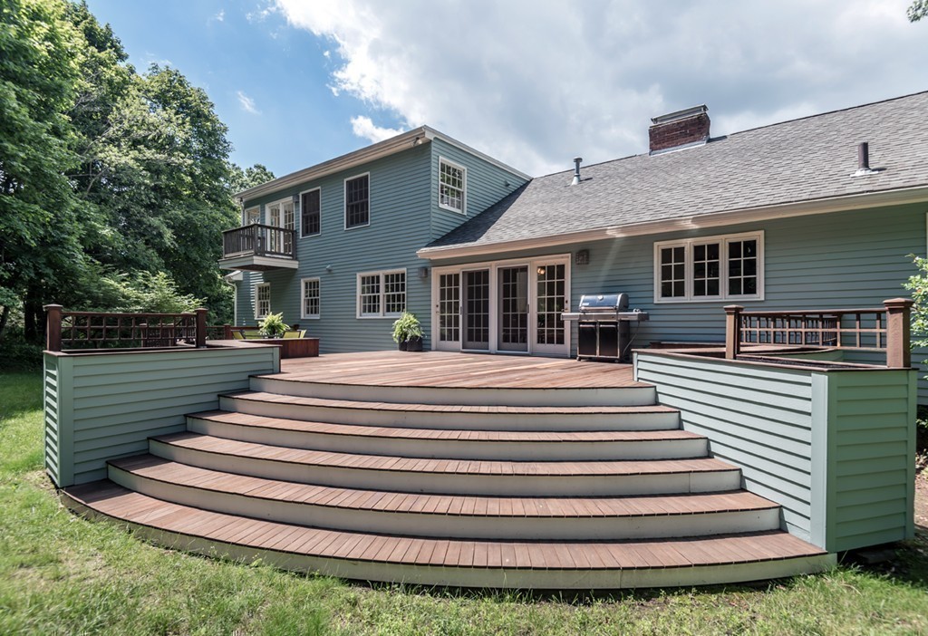 18 Wildwood Road Andover, MA 01810 - Photo 25 of 30 a front view of a house with a garden and plants