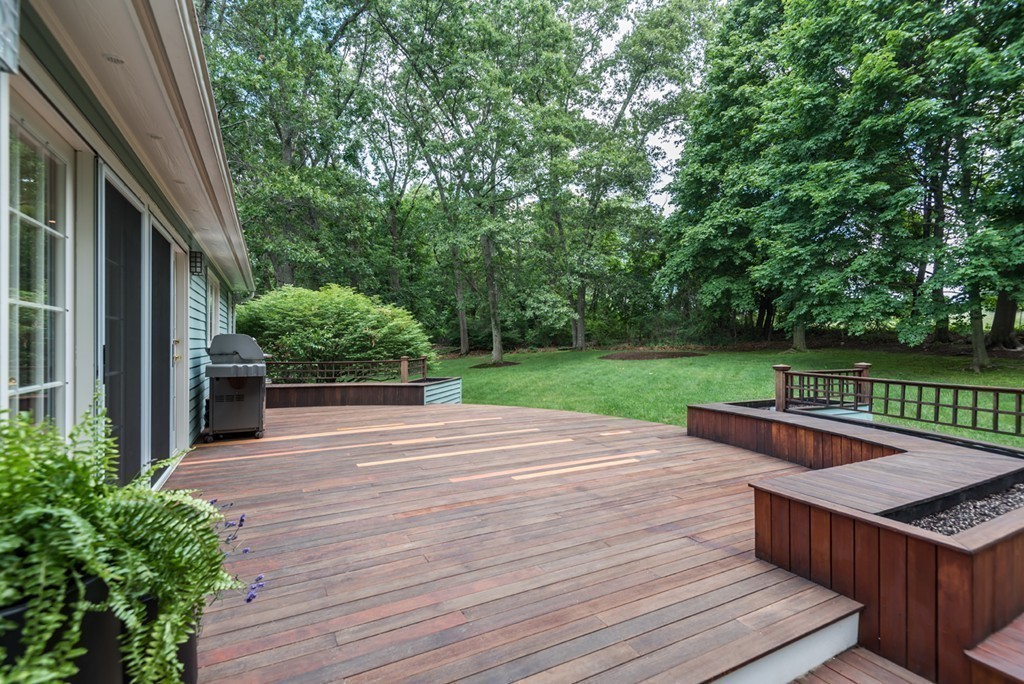 18 Wildwood Road Andover, MA 01810 - Photo 29 of 30 a patio with table and chairs and potted plants with wooden floor and fence