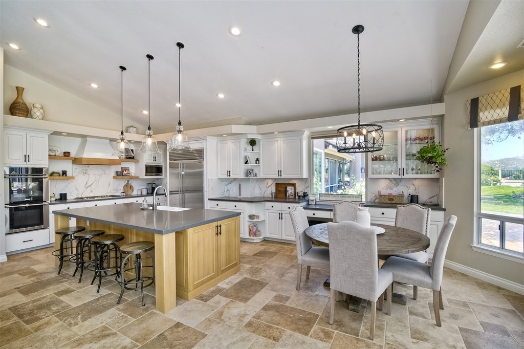 a large kitchen with a table and chairs