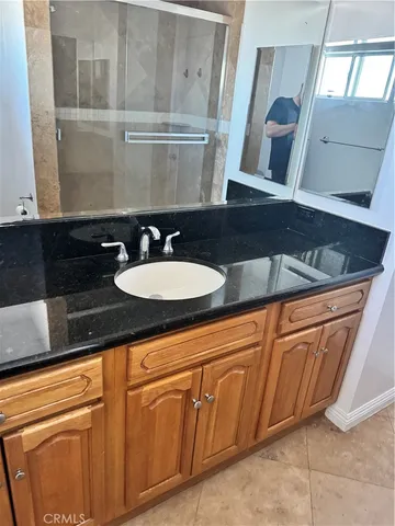 a bathroom with a sink a mirror and vanity