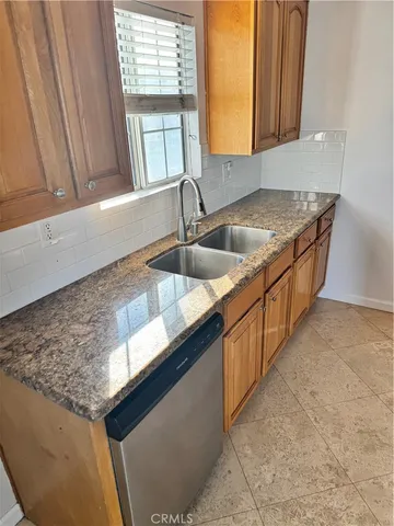 a kitchen with granite countertop a sink and a window