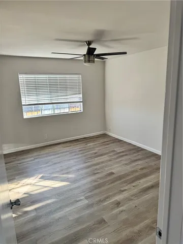 a view of a room with wooden floor and cabinet