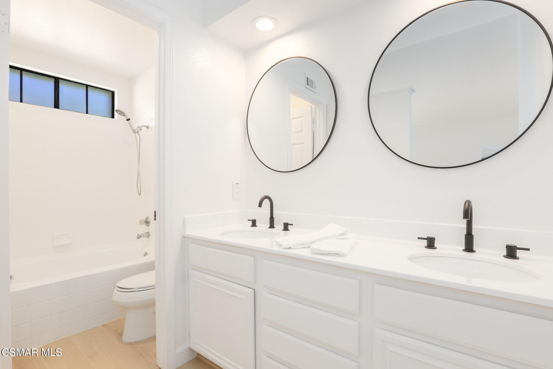 765 Congressional Road Simi Valley, CA 93065 - Photo 13 of 35 a bathroom with a toilet a sink a mirror and a shower